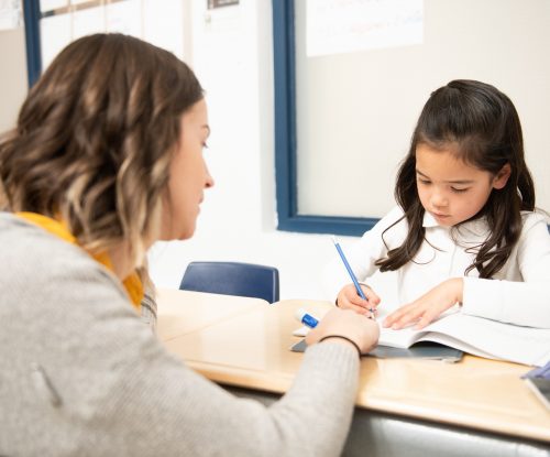 Teacher helping student in school