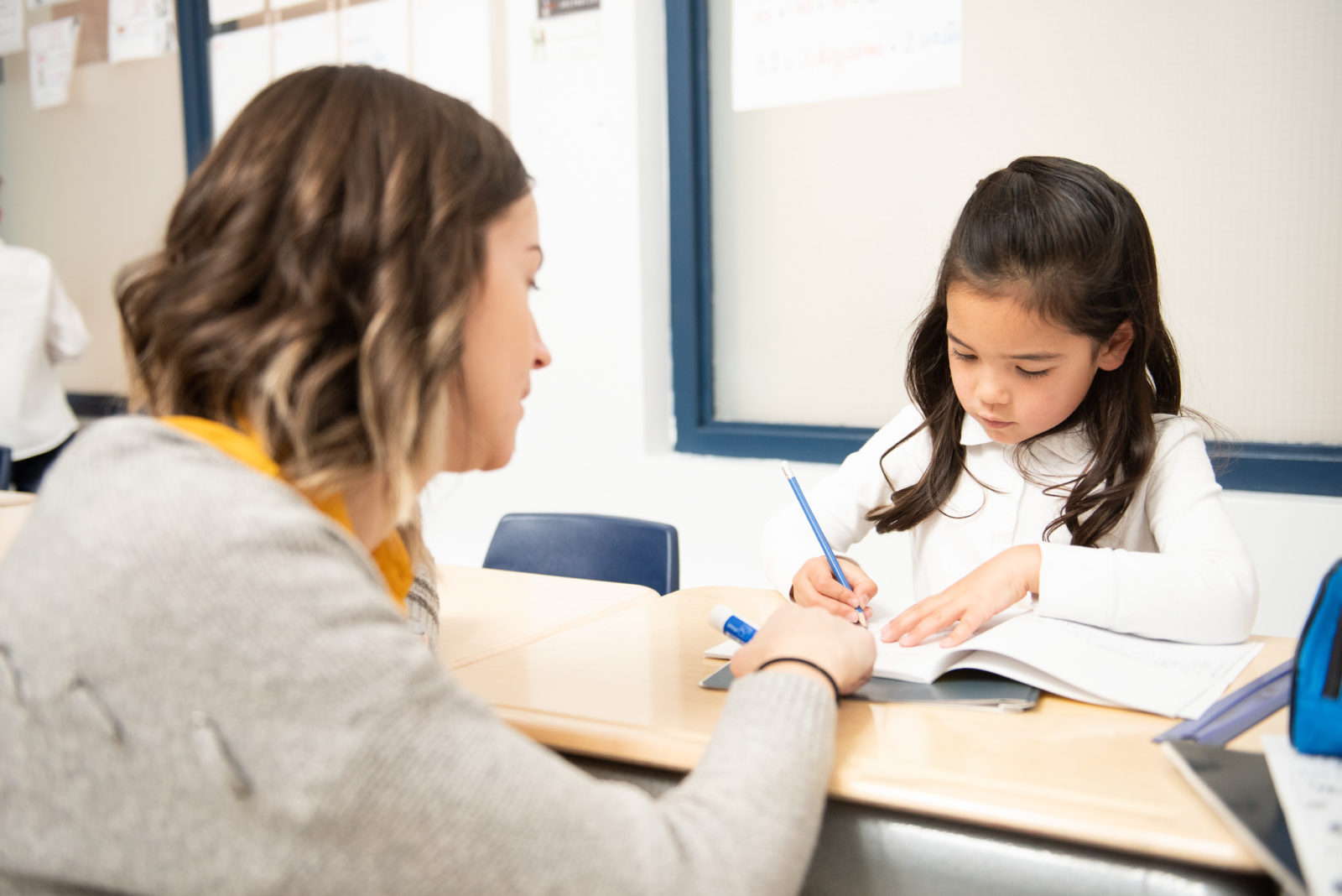 Teacher helping student in school
