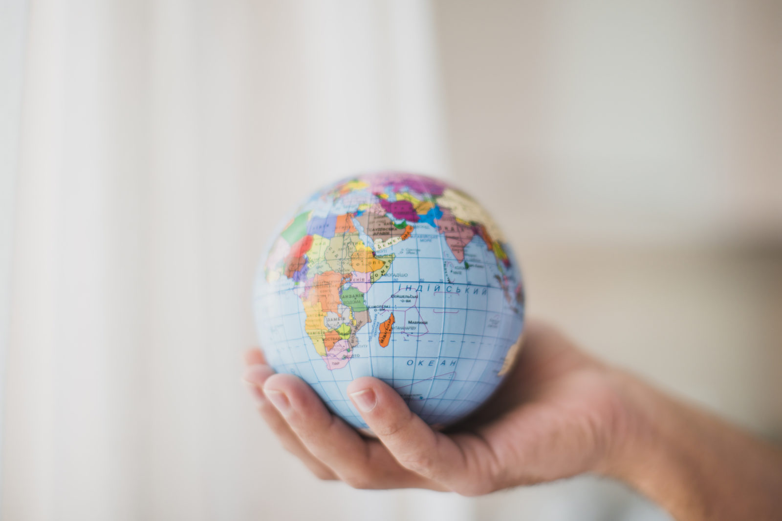 hand holding a globe